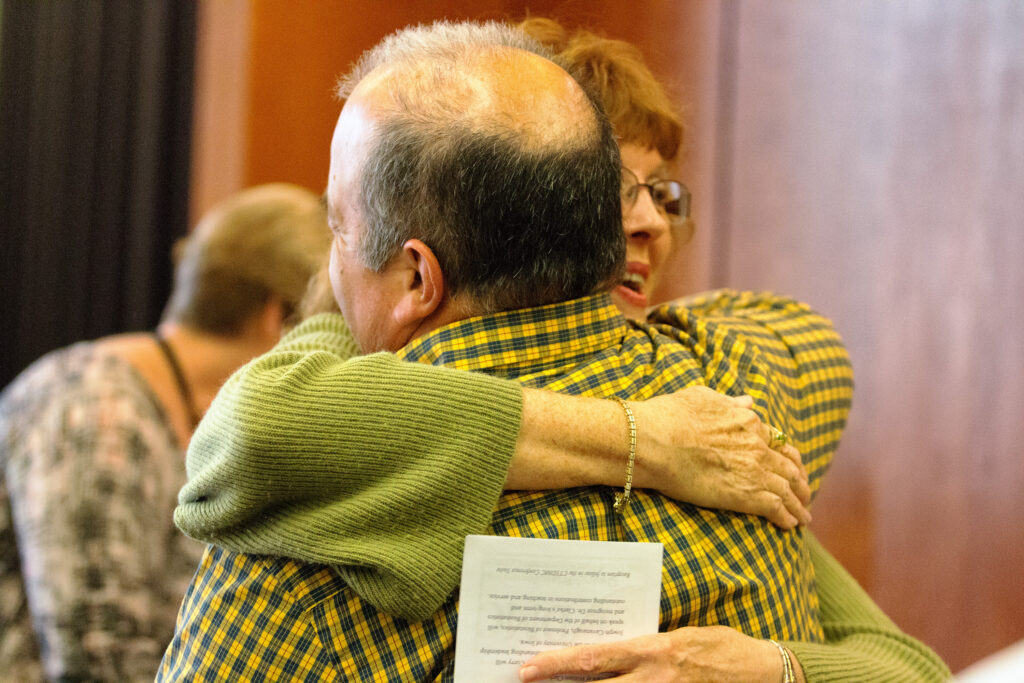 Patient families hugging at a NeuroNEXT event.